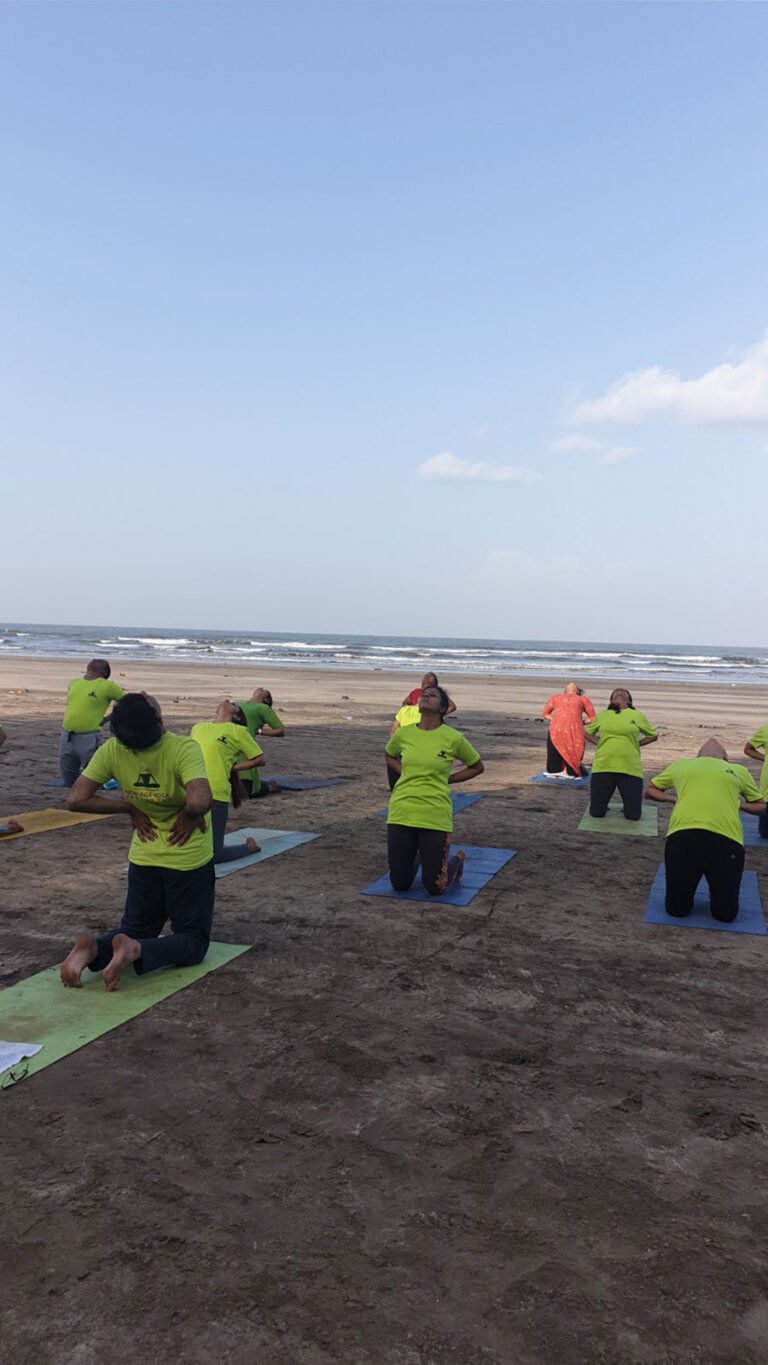 NAYI students practising yoga beside the sea